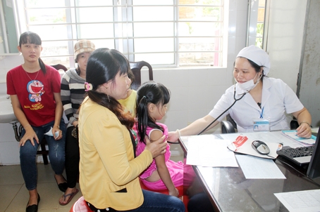 Bác sĩ Trung tâm y tế huyện Xuân Lộc khám cho bệnh nhi. Ảnh: Đ.Ngọc